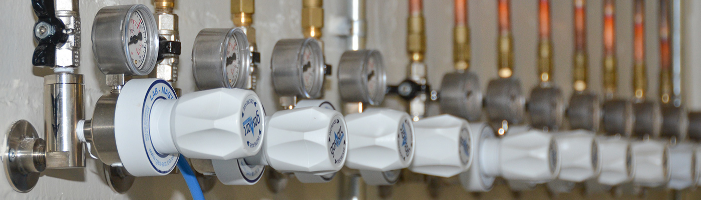 Taps connected to pipes in laboratory