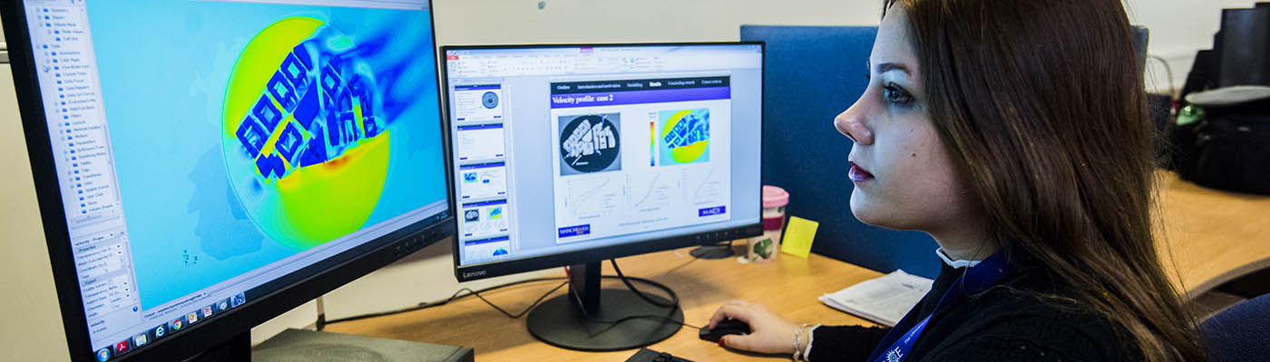 Female student working at a terminal showing fluid dynamic simulation