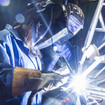 Female researcher welding