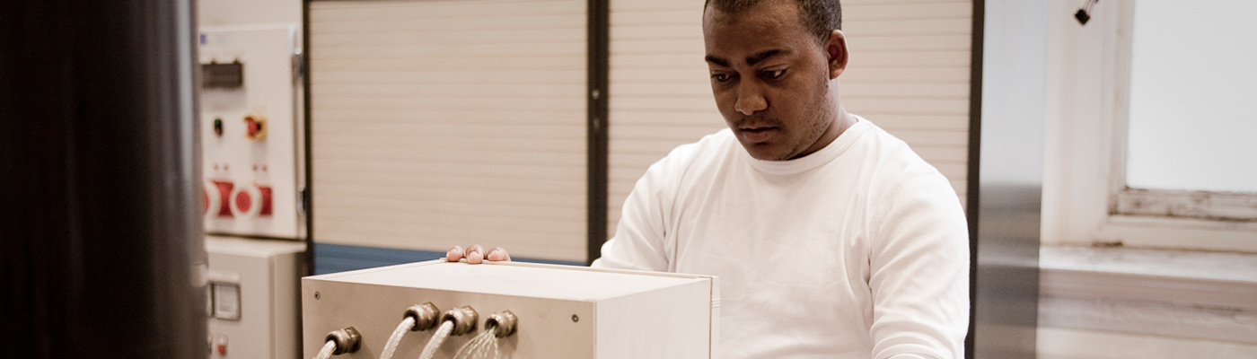 Researcher adjusting machinery in research centre
