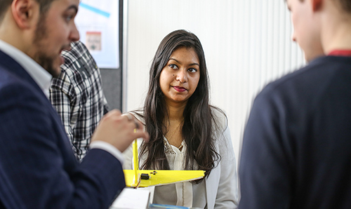 Student listening to conversation at an event