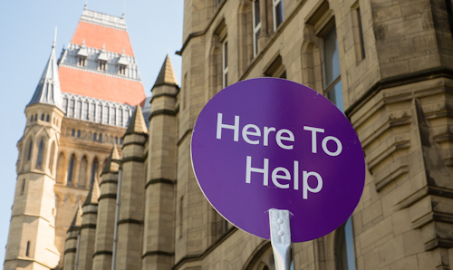 Sign saying here to help outside main university building